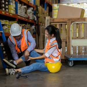 First aid support accident at work of worker at factory.