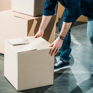 Loader man lifting cardboard box