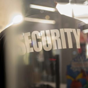 Security guard standing inside commercial building nearby the wi